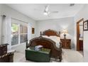 Spacious bedroom featuring an ornate wood-frame bed, neutral walls, and a bright window at 2102 Congress Ln, St Cloud, FL 34769