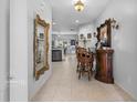 Elegant foyer with tile flooring, decorative mirrors, and a glimpse into the kitchen at 2102 Congress Ln, St Cloud, FL 34769