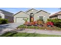 Inviting home with a well-manicured lawn and colorful flowerbeds enhancing the curb appeal at 2102 Congress Ln, St Cloud, FL 34769