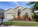 Attractive home boasts lovely landscaping, a two-car garage, and a well-maintained lawn at 2102 Congress Ln, St Cloud, FL 34769