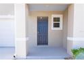Inviting front entryway featuring a stylish blue door and convenient covered porch at 2188 Tay Wes Dr, St Cloud, FL 34771