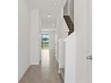 Bright hallway with tile flooring and stairs leading to the upper level at 2188 Tay Wes Dr, St Cloud, FL 34771