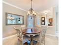 Cozy dining area with a round wood table and elegant chandelier lighting at 228 Sorrento Rd, Poinciana, FL 34759