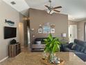 Comfortable living room with nautical decor, adjacent to granite countertop kitchen island at 2917 Kokomo Loop, Haines City, FL 33844