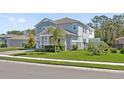 Beautiful home with landscaped yard, neutral paint, and a quaint front porch with stone accents at 3010 Camden Way, Davenport, FL 33837