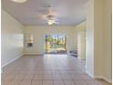 Bright living room offers tile floors, ceiling fan, and sliding glass doors to the outdoor patio at 3101 Yellow Lantana Ln, Kissimmee, FL 34747