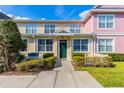 Charming townhome with colorful exterior, well-manicured landscaping, and inviting entryway at 4002 San Gallo Dr # 106, Kissimmee, FL 34741