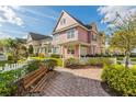 Charming street view of colorful townhomes with picket fences and well-maintained landscaping at 4002 San Gallo Dr # 106, Kissimmee, FL 34741
