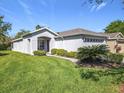 Charming single-story home with well-manicured lawn, shrubbery, and a brick-paved driveway at 439 Madera Pass, Poinciana, FL 34759