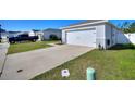 The exterior of this home has a well-manicured lawn and a two-car garage with a double wide driveway at 4677 Glencrest Loop, St Cloud, FL 34772