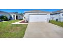 Well maintained lawn and landscaping accent the exterior of this home with a long driveway to a two-car garage at 4677 Glencrest Loop, St Cloud, FL 34772