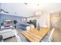 Modern living room flows into a kitchen with stainless steel appliances and island seating at 4835 Lullaby Ln, Kissimmee, FL 34746