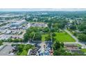 Expansive aerial view showcasing a lush green lot with mature trees, and an advantageous location near an industrial area at 512 Palmetto St, Orlando, FL 32824