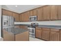 Spacious kitchen with stainless steel appliances, granite countertops and ample cabinet space at 545 Fairhaven Dr, Davenport, FL 33837