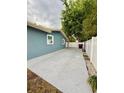 Spacious paved driveway, adjacent to a white fence, with convenient side yard access at 6337 Lido Ct, Orlando, FL 32807