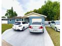 Charming single-story home with a well-maintained lawn and driveway featuring multiple vehicles at 6337 Lido Ct, Orlando, FL 32807