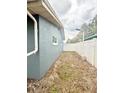 Side yard with a white fence offers privacy and potential for outdoor customization at 6337 Lido Ct, Orlando, FL 32807