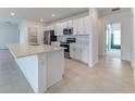 Kitchen featuring an island, stainless steel appliances, and white cabinets at 64 Citrine Loop, Kissimmee, FL 34758