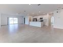 Spacious living room leads into the kitchen with recessed lights and tile floors at 64 Citrine Loop, Kissimmee, FL 34758