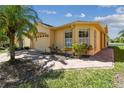 Charming home exterior featuring well-maintained landscaping, a brick walkway, and a two-car garage at 782 Vineyard Way, Poinciana, FL 34759