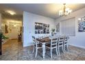 Cozy dining room featuring a wooden table with seating for six under a stylish chandelier at 8945 Cuban Palm Rd, Kissimmee, FL 34747