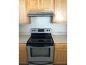 Kitchen featuring neutral countertops, cabinets, and modern stove at 9061 Lee Vista Blvd # 1303, Orlando, FL 32829