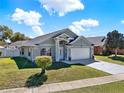 Inviting single-level home with well-kept lawn, showcasing a welcoming curb appeal at 905 Woodsong Way, Clermont, FL 34714