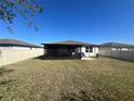 A spacious yard with a screened patio offers an inviting outdoor living area for relaxing or entertaining at 1249 Oak Valley Dr, Auburndale, FL 33823