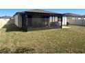 Spacious backyard with a screened-in patio, perfect for outdoor relaxation and entertainment at 1249 Oak Valley Dr, Auburndale, FL 33823