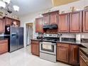 Kitchen with stainless steel appliances, dark cabinets, and granite countertops at 147 Pompei Dr, Kissimmee, FL 34758