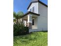 View of the home's covered front porch, showcasing stone column accents, neat landscaping, and a well-maintained lawn at 15007 Night Heron Dr, Winter Garden, FL 34787