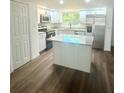 Modern kitchen boasts stainless steel appliances, granite countertops, and a center island for added workspace at 1539 Roselawn Sw St, Winter Haven, FL 33880