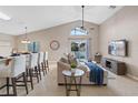 Bright, open living area featuring a vaulted ceiling, tile floors, and access to the pool area at 215 Highgate Park Blvd, Davenport, FL 33897