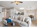 Cozy living room with modern furnishings, open to the kitchen and dining area at 215 Highgate Park Blvd, Davenport, FL 33897
