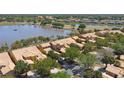 An aerial view showcases townhomes and a tranquil lake, creating a scenic and desirable community at 2340 Palm Tree Dr, Kissimmee, FL 34759