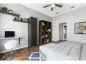Cozy bedroom with built-in desk, floating shelves, and hardwood floors at 2566 Conway Gardens Rd, Orlando, FL 32806