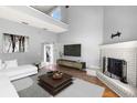 Bright living room with high ceilings, modern decor, fireplace, and hardwood floors at 2566 Conway Gardens Rd, Orlando, FL 32806
