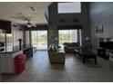 Open-concept living space with views of the pool, featuring tile flooring and plenty of natural light at 2677 Emerald Island Blvd, Kissimmee, FL 34747