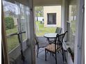 Screened patio featuring outdoor seating, a small table, and an electric scooter at 2706 Club Cortile Cir, Kissimmee, FL 34746