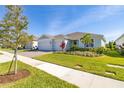 Beautiful single-story home featuring a brick driveway, two-car garage and meticulously landscaped front yard at 2719 River Creek Ln, St Cloud, FL 34771