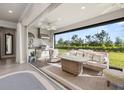 Inviting outdoor living area with comfortable seating, built-in grill, and scenic backyard views at 2719 River Creek Ln, St Cloud, FL 34771