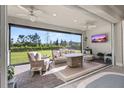 Relaxing screened-in patio with comfortable wicker furniture and serene backyard views at 2719 River Creek Ln, St Cloud, FL 34771