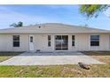Rear exterior view featuring a patio and sliding glass door, perfect for indoor-outdoor living at 2804 Latter Day Ct, St Cloud, FL 34769