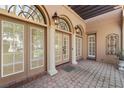 Elegant entrance with arched doorways, stone columns, and decorative lighting, creating a welcoming and grand first impression at 304 Acadia Ln, Celebration, FL 34747