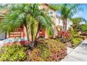 Townhouse featuring vibrant landscaping, walkway, and inviting curb appeal at 4743 Vero Beach Pl, Kissimmee, FL 34746