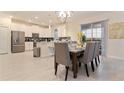 Elegant dining area adjacent to a modern kitchen with bar stool seating at 481 Ocean Course Ave, Davenport, FL 33896