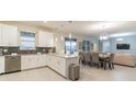 Open concept kitchen with stainless appliances flowing into dining and living areas at 481 Ocean Course Ave, Davenport, FL 33896