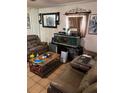 Cozy living room featuring brown leather furniture, tile floors, and an aquarium as a focal point at 4834 Ute St, Orlando, FL 32819