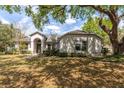 Charming single-story home with lush landscaping, mature trees and inviting curb appeal at 4911 Lazy Oaks Way, St Cloud, FL 34771