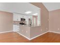 An open kitchen features white cabinets, granite countertops, and stainless steel appliances at 50 Sawfish Ct, Kissimmee, FL 34759